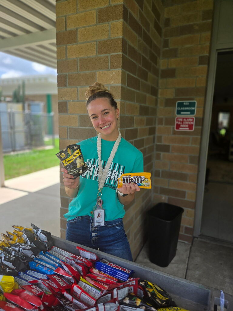 Miss Kimmel holding treats from the Dragon Wagon