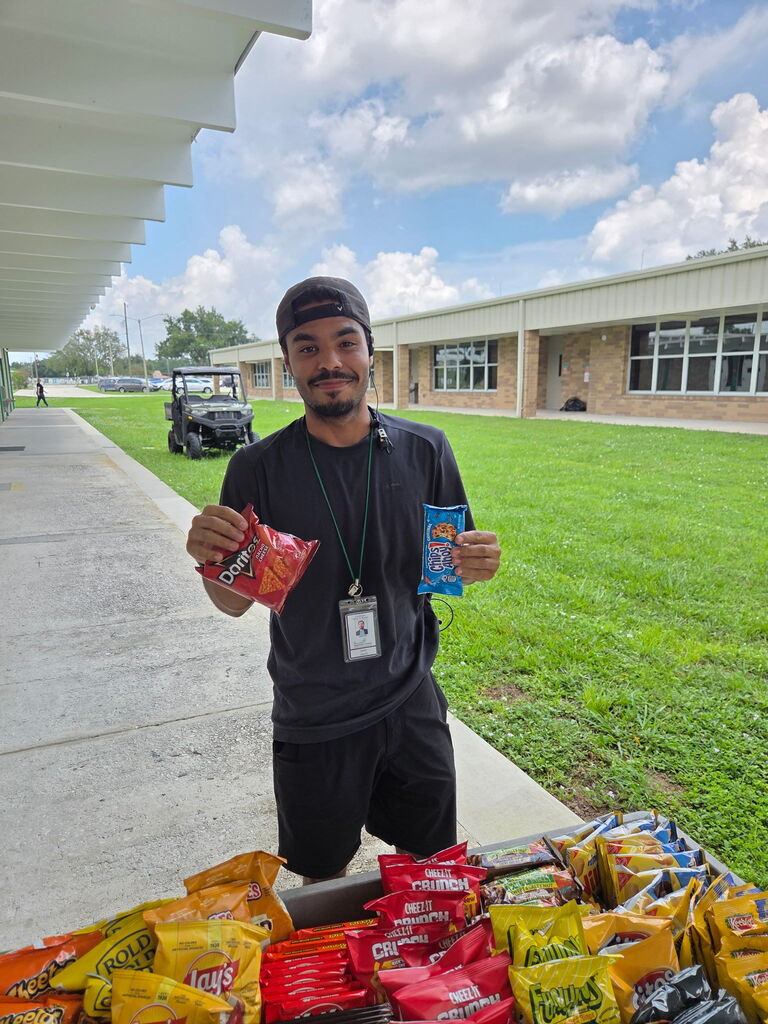 Mr. Cancel holding treats from the Dragon Wagon