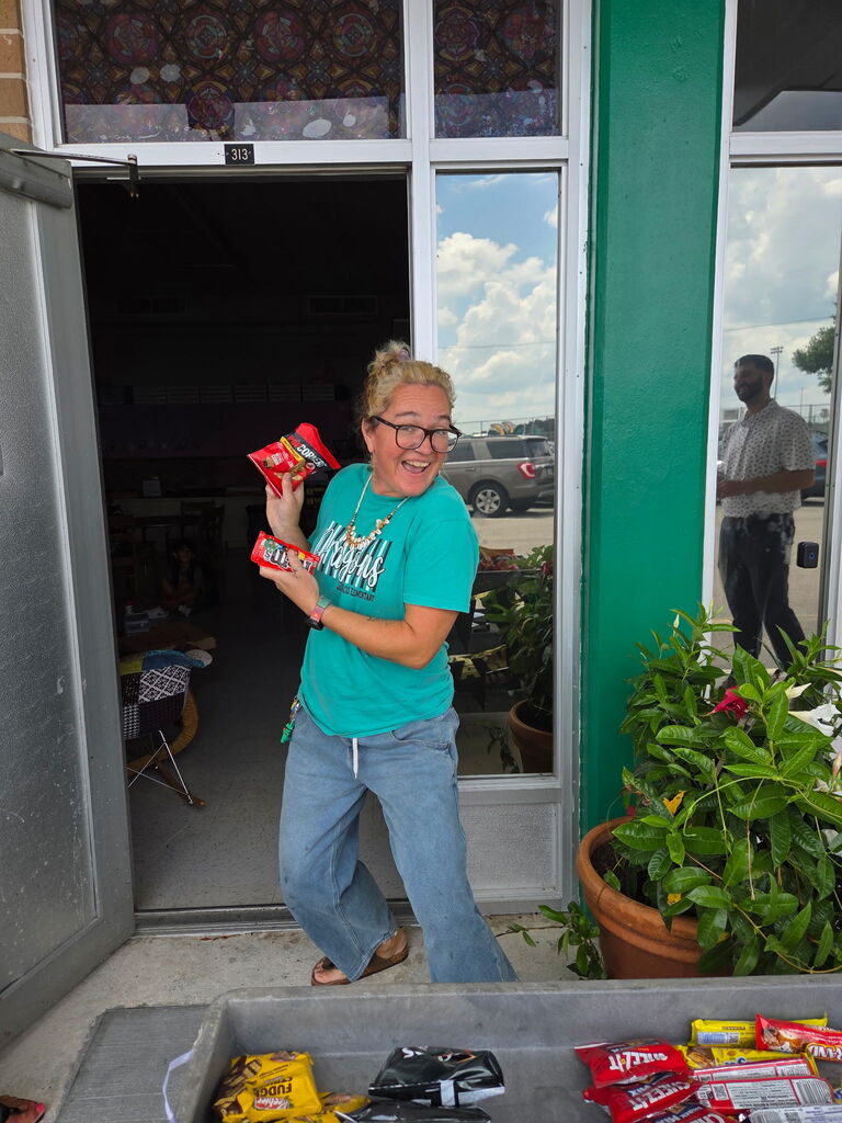 Picture of Ms. Groover holding treats from the Dragon Wagon.