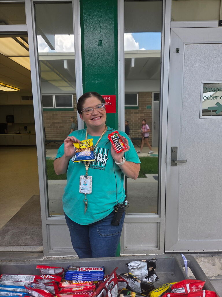 Picture of Mrs. Wright holding goodies from the Dragon Wagon.