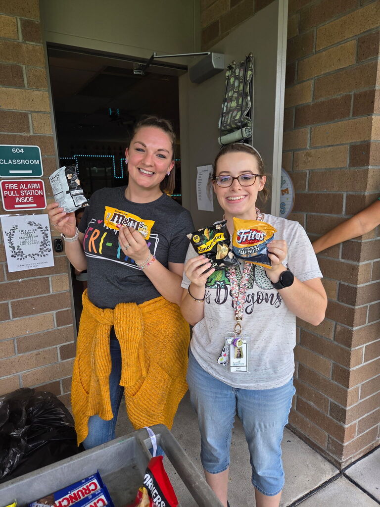 Mrs. Lanier and Miss Williams holding treats from the Dragon Wagon