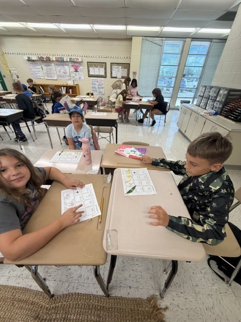 In Mrs. Wolfhope’s classroom, students are reviewing plant structures—including roots, stems, leaves, flowers, seeds, and fruit—and learning about the important roles each part plays in helping plants grow, survive, and reproduce.