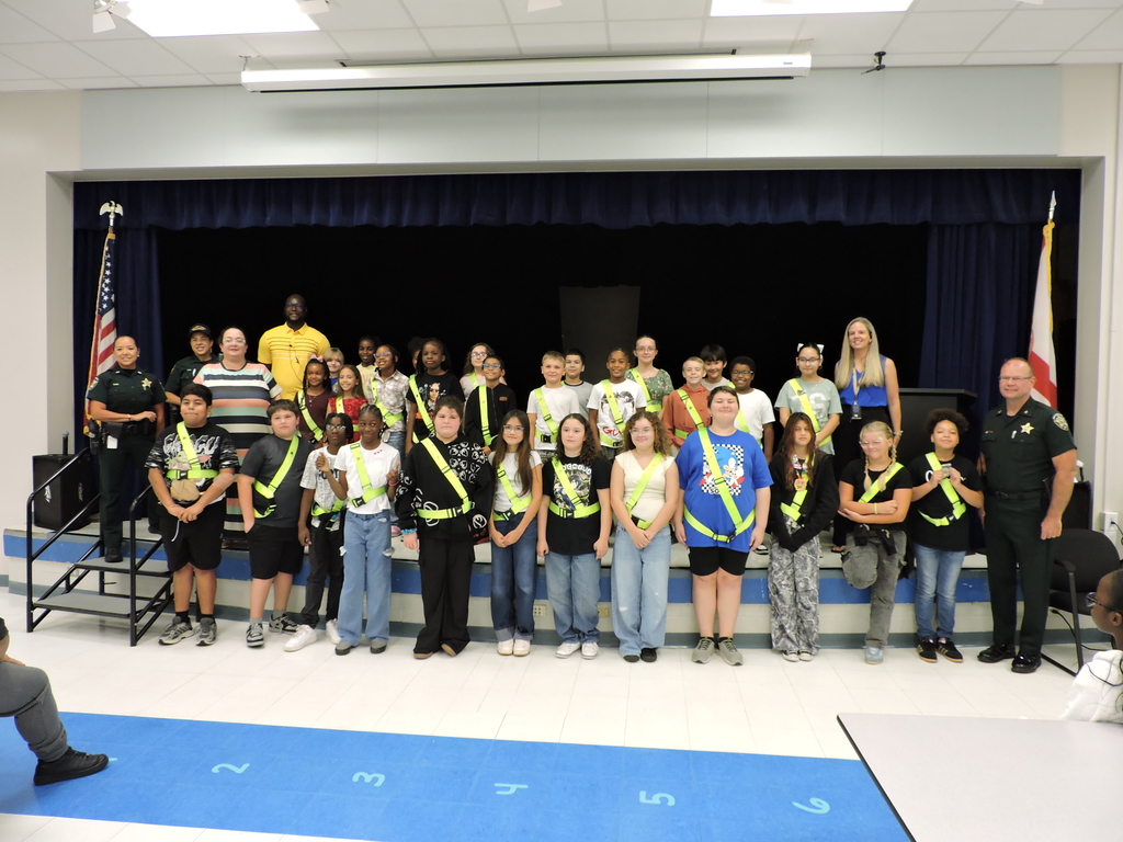 Sheriff Blackman, Lieutenant Gunn, Mrs. Kaseman, and Fred Wild administrators pose with the 2026-2027 Fred Wild Elementary Safety Patrol students.