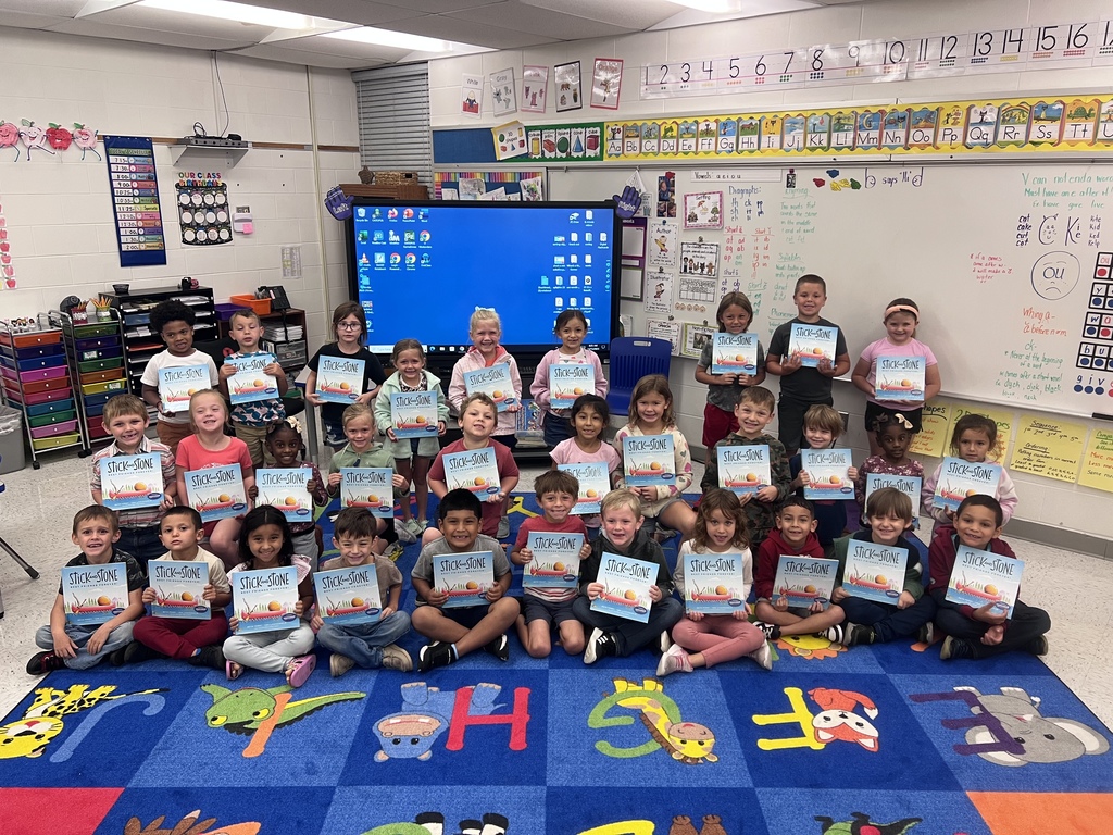 Kindergarten students holding the book, Stick and Stone: Best Friends Forever!