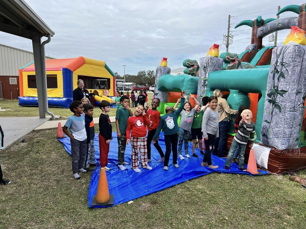 Students enjoing the bounce houses