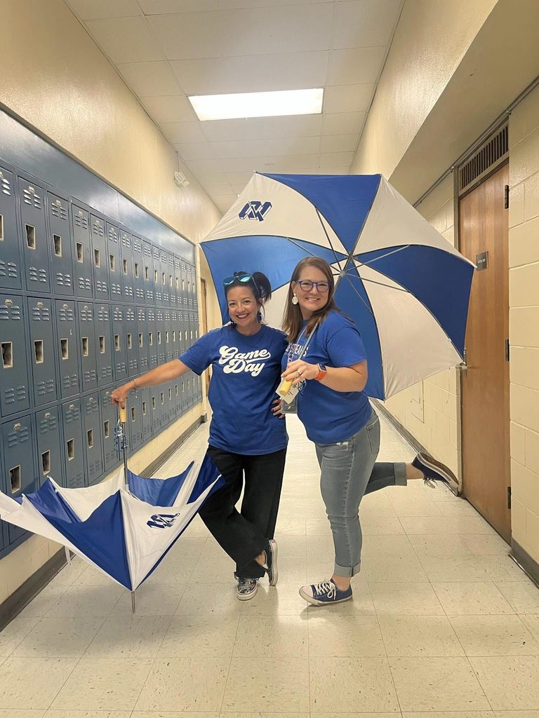 Mrs. Dewitt and Mrs. Miller showing off the new umbrellas