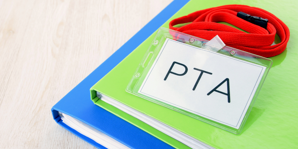 Lanyard with a PTA name tag and notebooks
