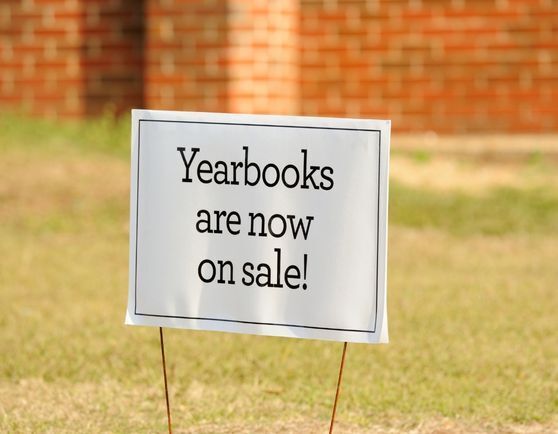 Yard sign with words, "Yearbooks are now on sale!"