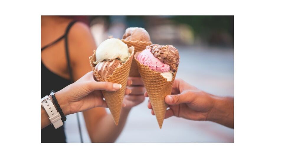 people holding ice cream cones