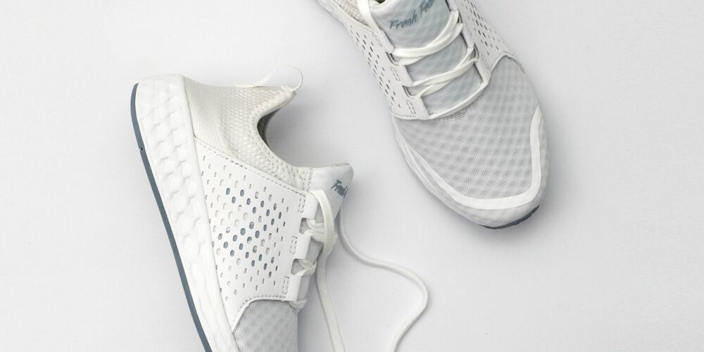 White gyms shoes with the laces untied