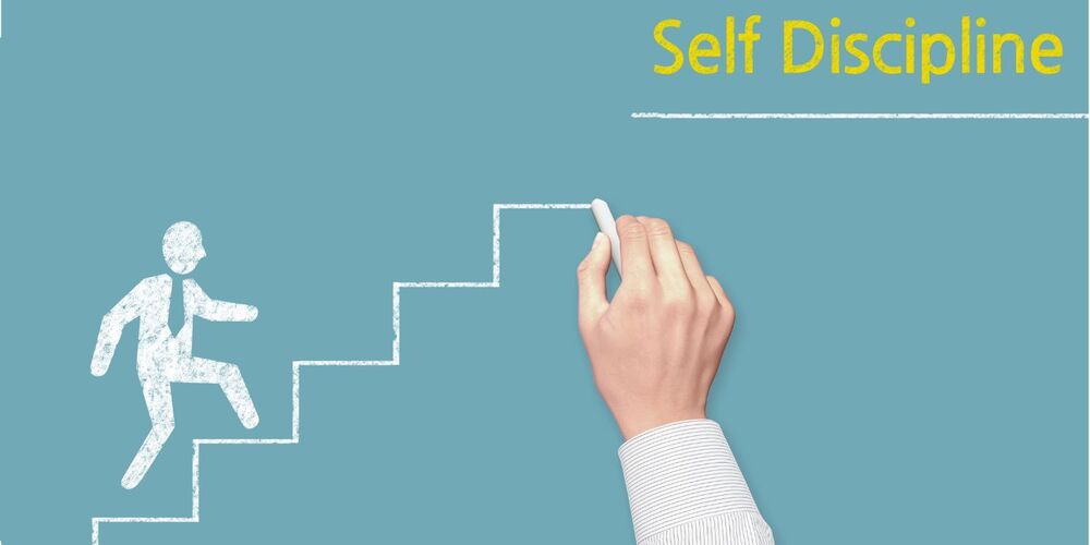 Chalk figure walking up stairs towards the words self discipline