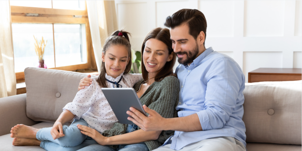 Parents and child looking at a tablet
