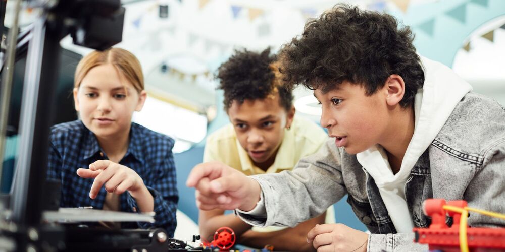 Three students working on an engineering project