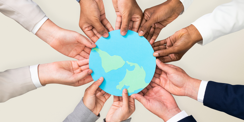 image of hands of different cultures holding a globe.