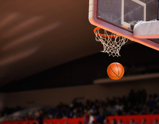 Basketball going through a basketball hoop.