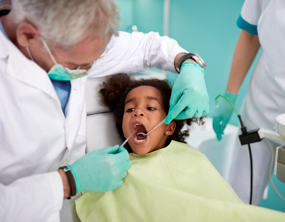 Dentist working on child's teeth.