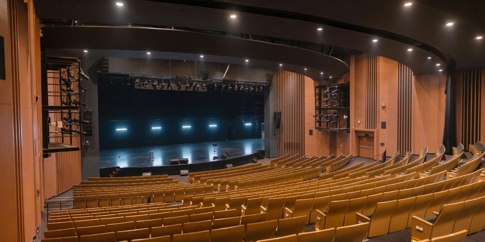 Wide view of a theater with a stage