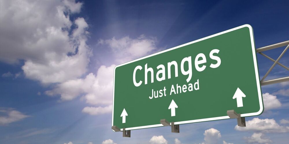 Road sign that reads changes ahead with blue sky and skattered clouds in the background