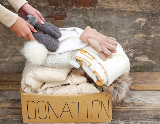 A donation box with winter clothing in it