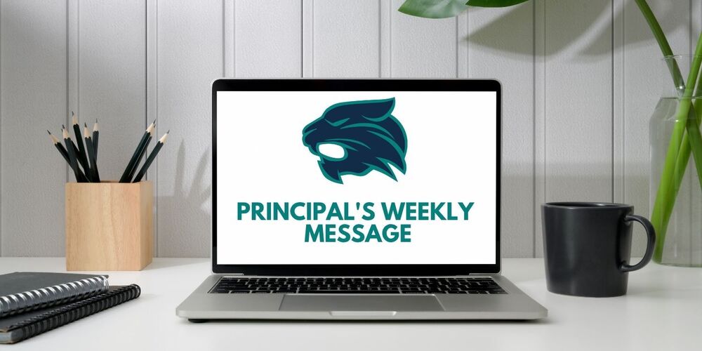 laptop and pencils, mugs, and noteboks on a desk. on the screen of the laptop theres is the keller logo and the words principal's weekly message