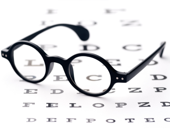 Glasses on top of eye exam letters