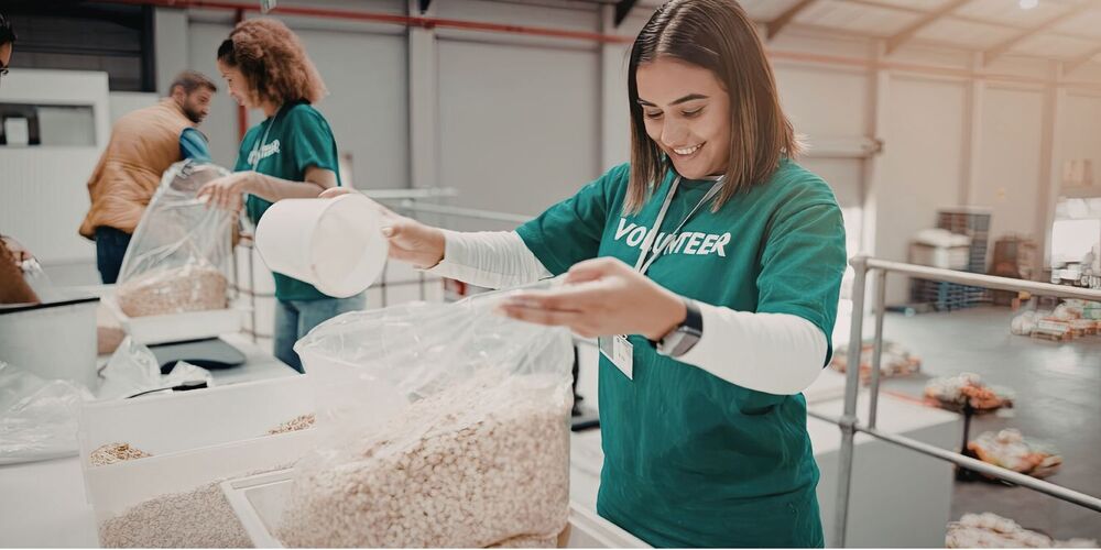 People packaging food in plastic bags
