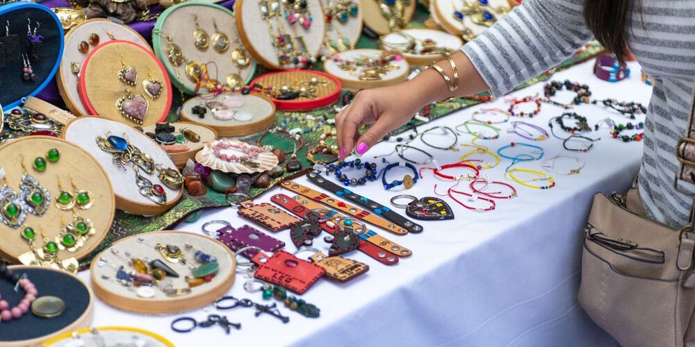 Crafts on a table with a lady's arm  picking up an item