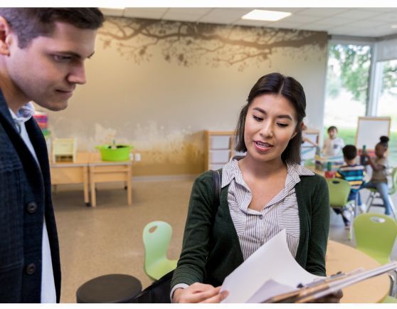 Woman showing a man some papers