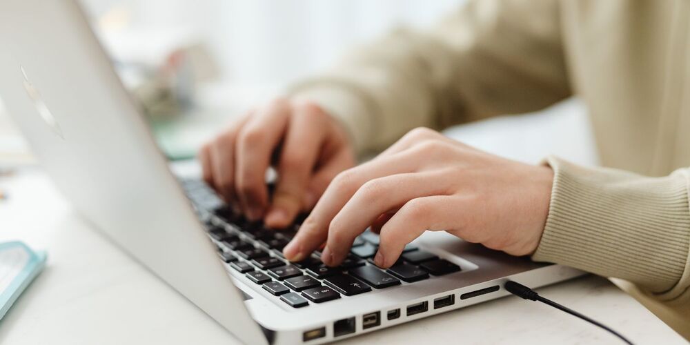 Person typing on a laptop computer