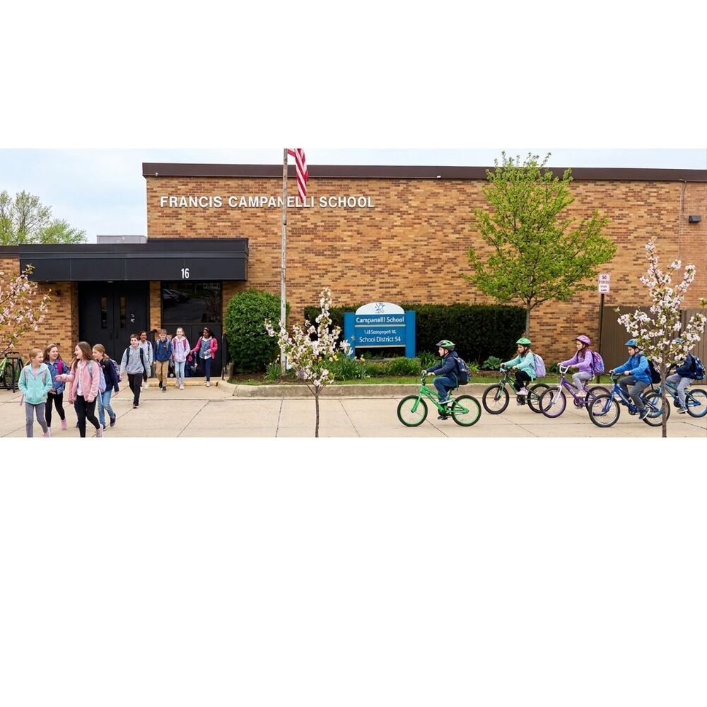 Photo of students on bikes in front of Campanelli