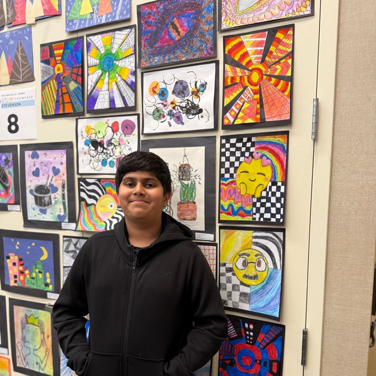 student standing next to artwork