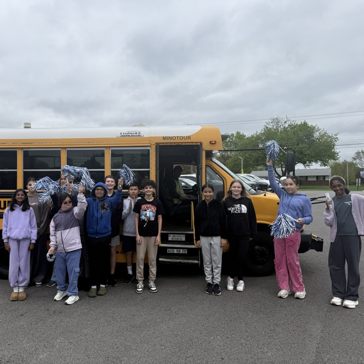 students standing in front of a bus