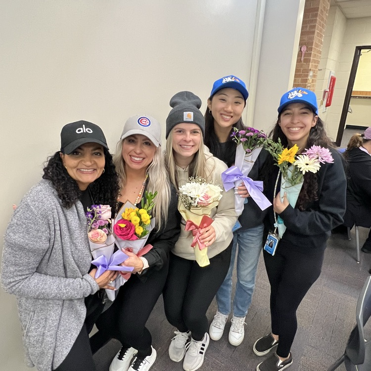five teachers standing with their flower bouquets 