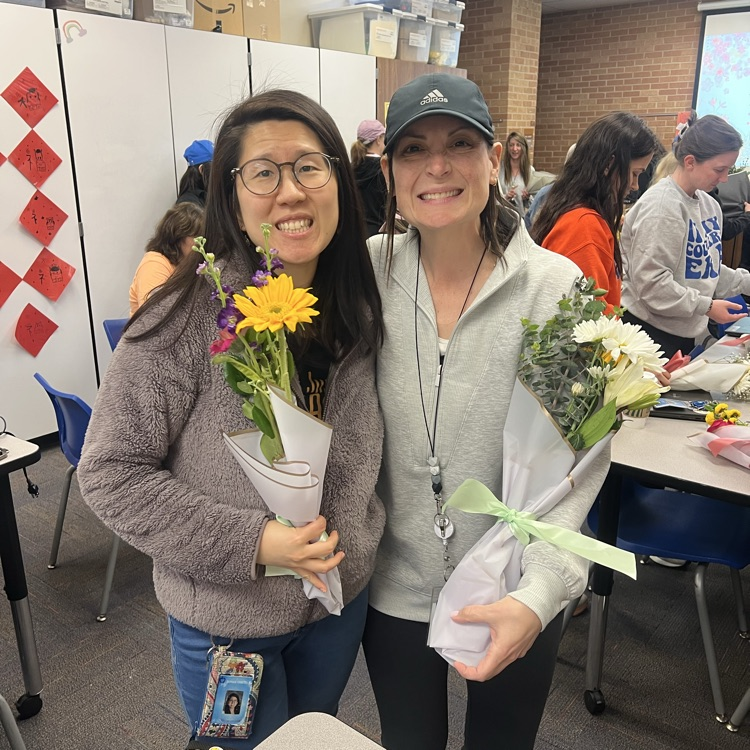Ms. Shao and Mrs. Schaefer holding their flower bouquets
