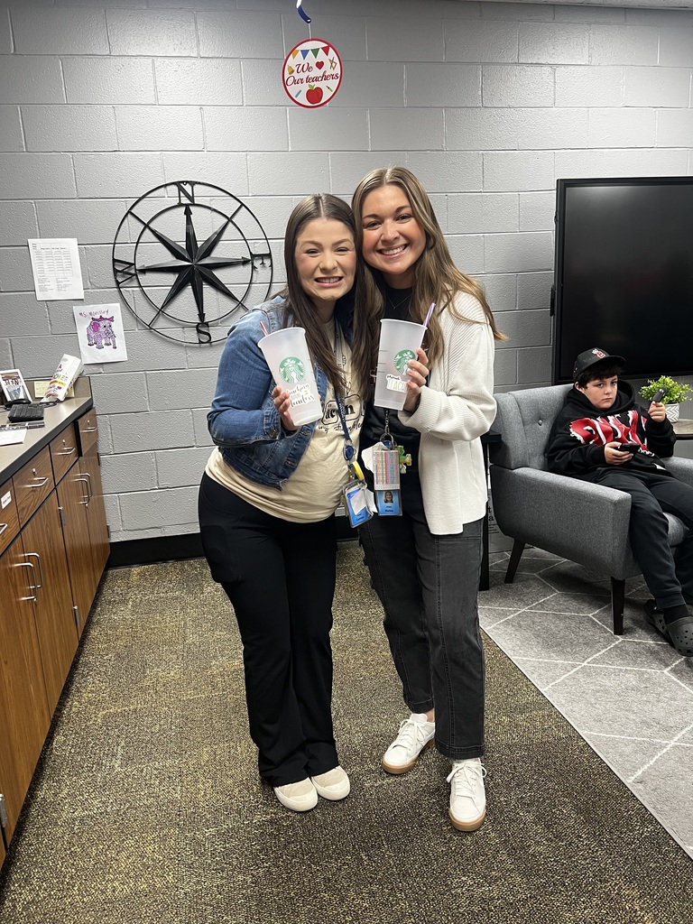 Teachers posing with coffee cups