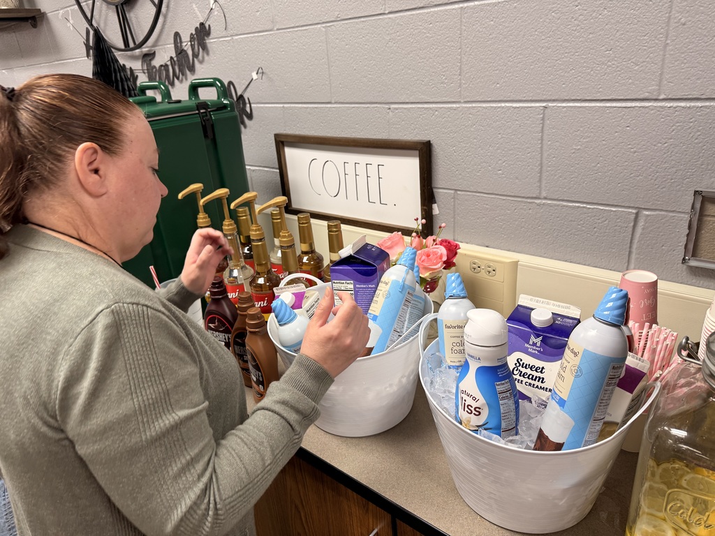 Teacher getting toppings from the coffee bar