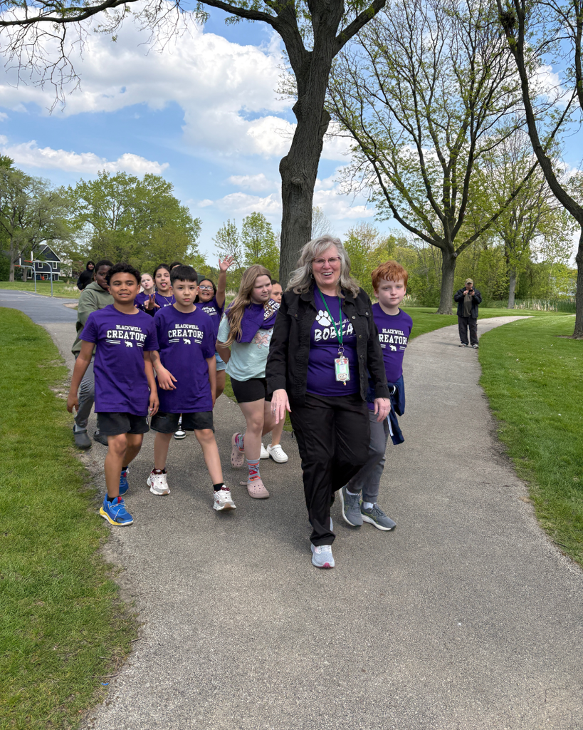 Teacher and student smiling and walking on the path