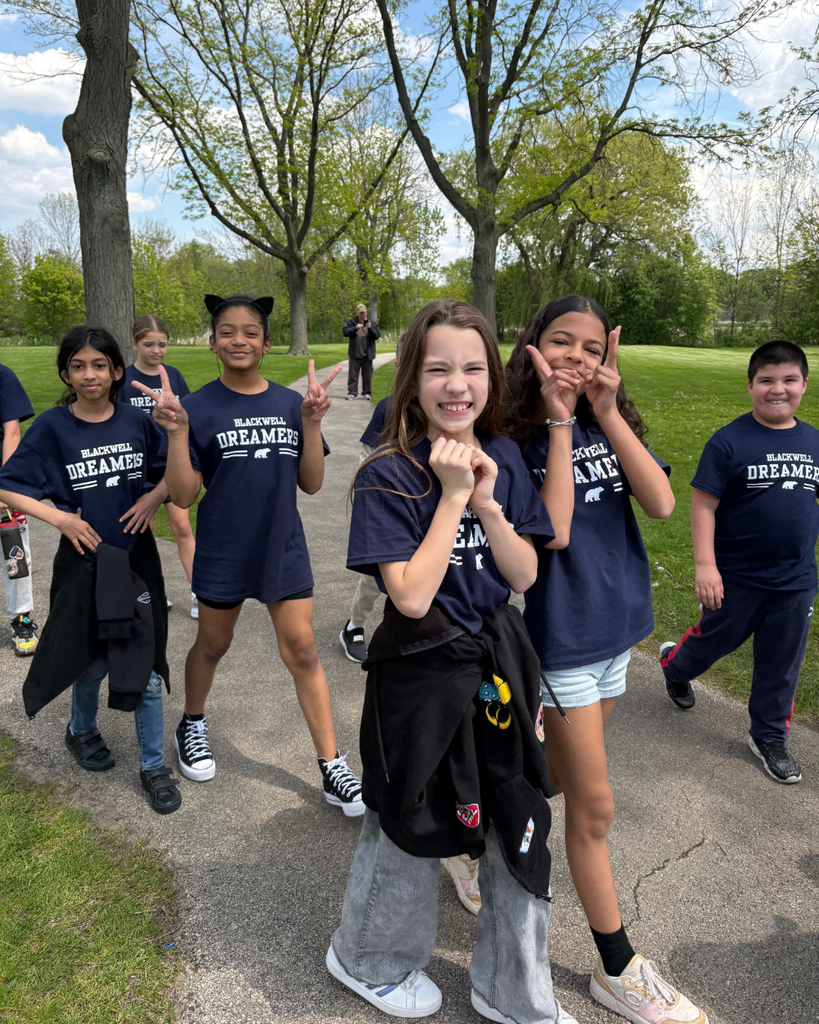 Students smiling and walking on the path