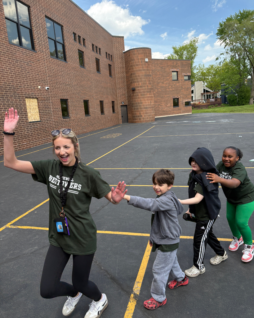 Teacher and students smiling and dancing