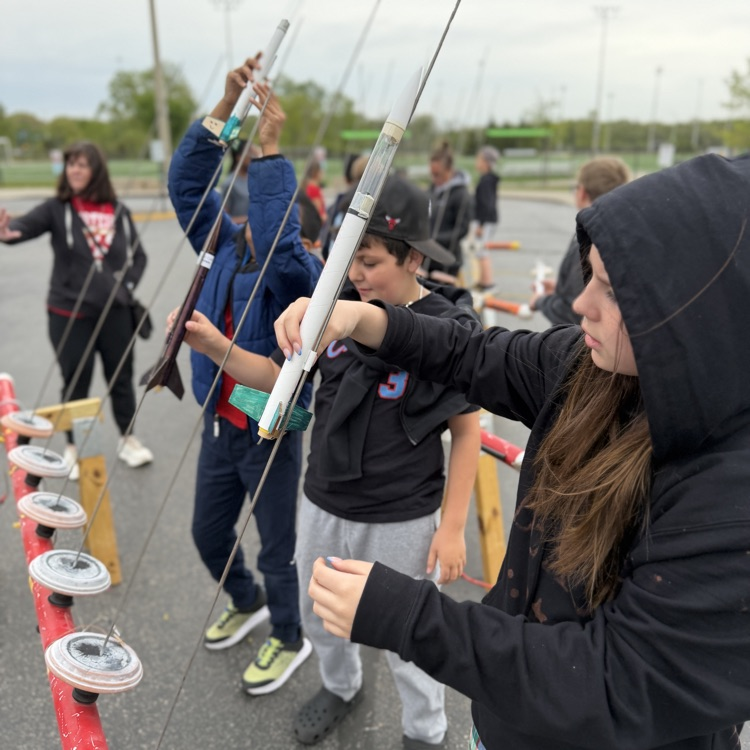 Students putting rockets on launch pad