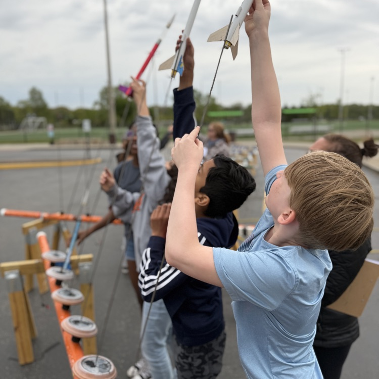 Students putting rockets on launch pad