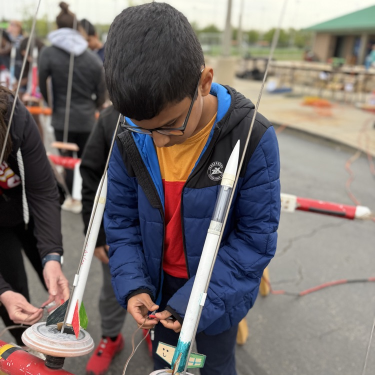 Students putting rockets on launch pad
