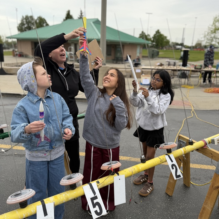 Students putting rockets on launch pad
