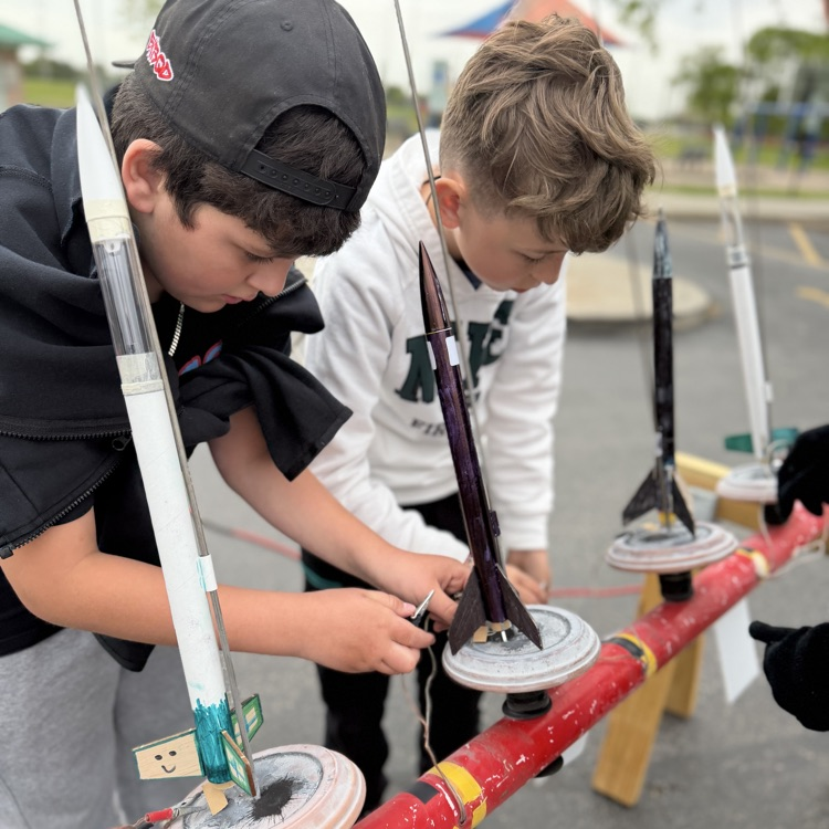 Students putting rockets on launch pad