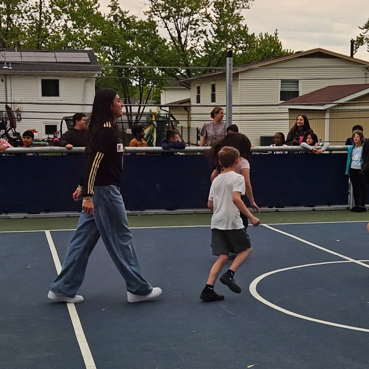 Third graders playing soccer outside 