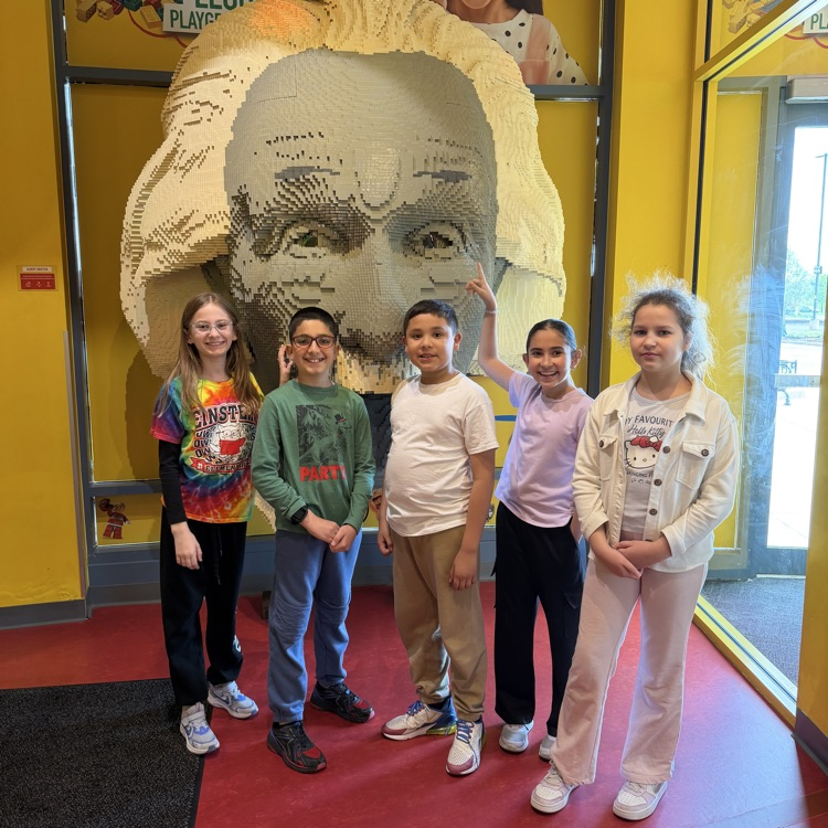 Fourth graders posing with LEGO Einstein