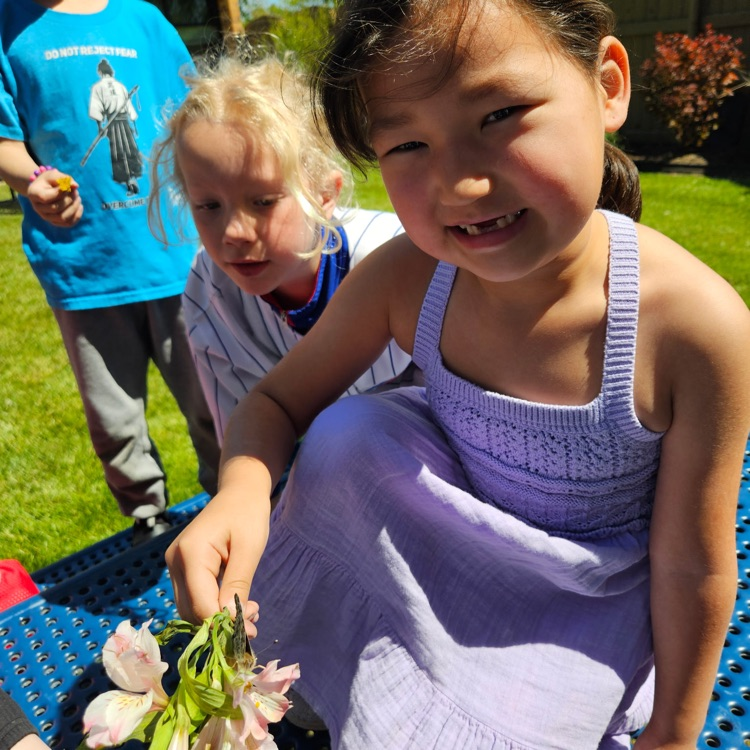 students holding a butterfly 