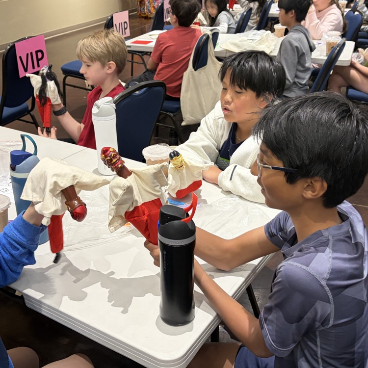 three boys doing a Chinese cultural activity 