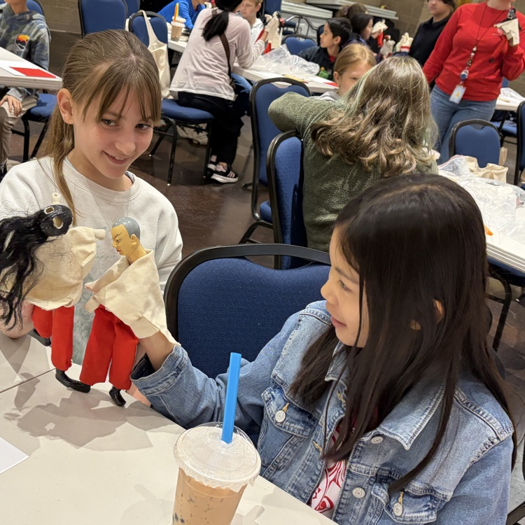 two girls doing a Chinese cultural activity 