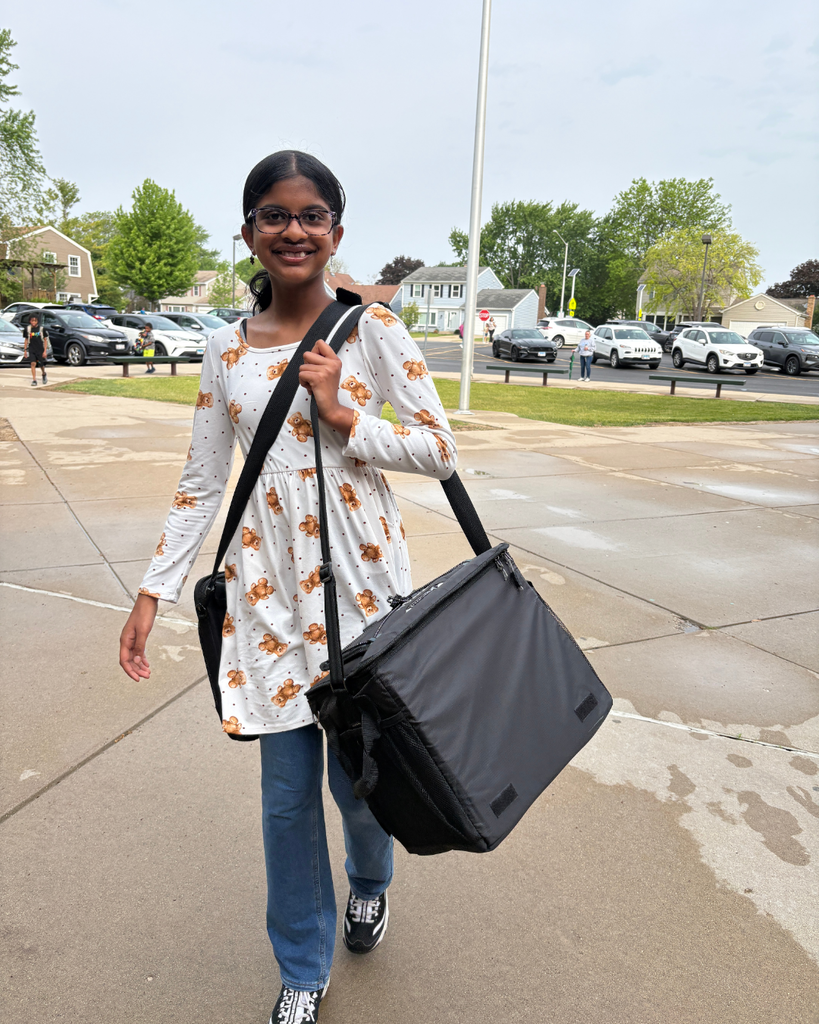Student carrying a bag into school